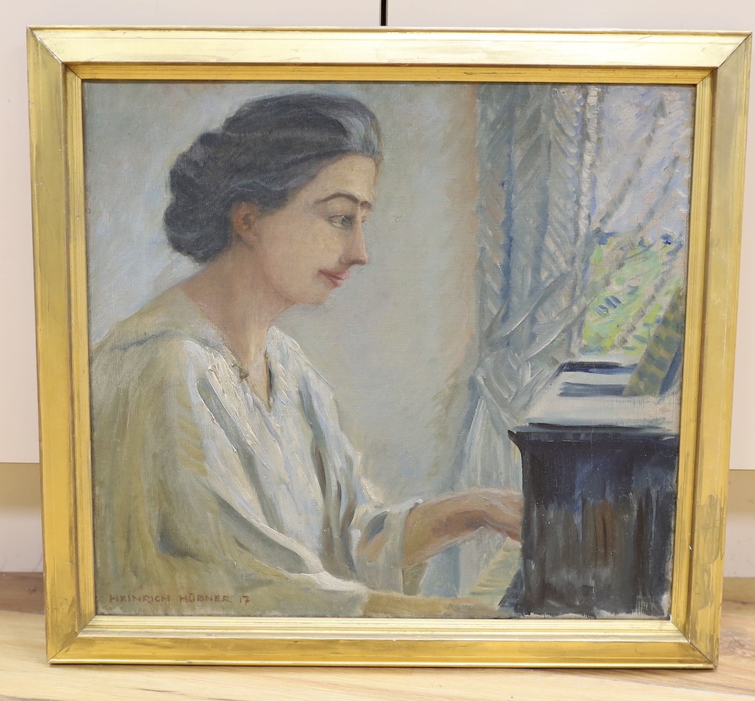 Heinrich Hübner (German, 1869-1945), oil on canvas, Lady playing the piano, signed and dated '17, 42 x 46cm